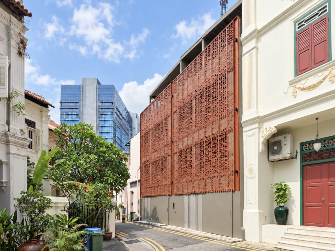 Addition and alteration works completed in 2025: a perforated terracotta screen wall rising behind the conserved shophouse frontage