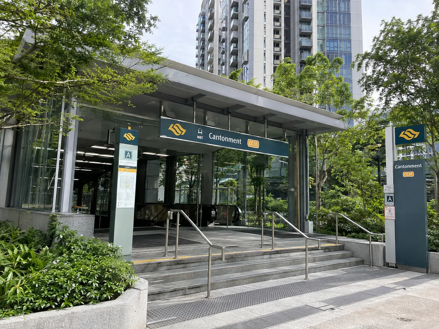 Entrance A of Cantonment MRT station (CC31), its canopy and signage set among street trees with residential towers behind