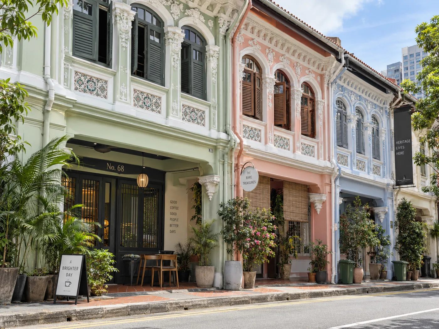 Row of conserved shophouses in mint, coral and pale blue with decorative tilework and timber shutters, a 'heritage lives here' banner at the end of the row